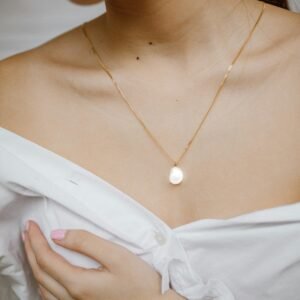Delicate gold necklace detail